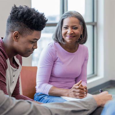 BIPOC senior woman and young man in therapy